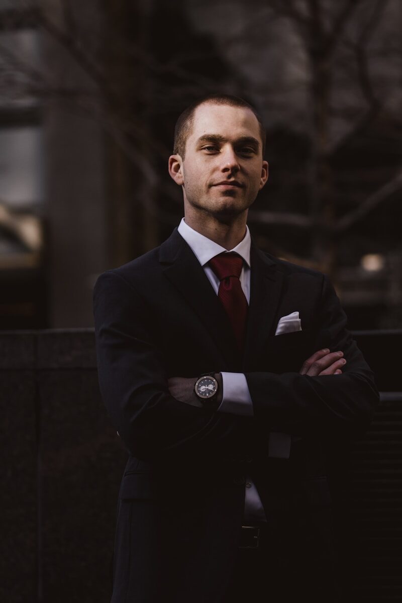 Photo by Ali Morshedlou man wearing black notched lapel suit jacket in focus photography